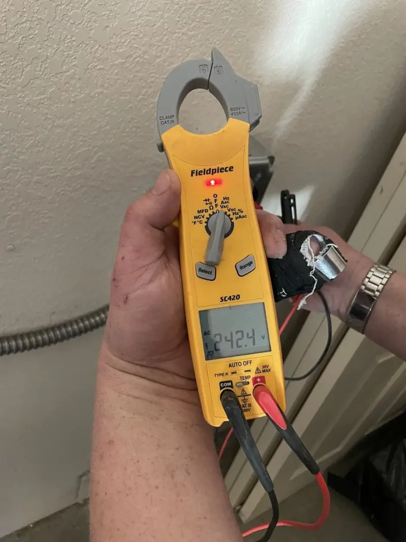 Voltage testing with clamp meter during Ceiling Fan Installation in Clearwater